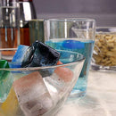 Two purple silicone ice cube trays, possibly Elbee Home brand, with one showing 15 individual square cube cavities.