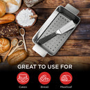 Elbee Home stainless steel meatloaf pan featuring a removable, perforated inner tray for easy grease drainage and lifting, shown with a matching serving spatula.