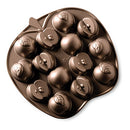 Nordic Ware cast aluminum apple slice cakelet pan with 14 nonstick cavities shaped like apple slices, shown on a white background.