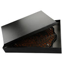Art Judaica wooden challah board with engraved Hebrew and a serrated bread knife.