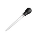 A Farberware clear plastic basting tool with a black rubber bulb, used for drawing and dispensing liquids.