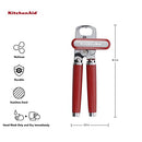 Red handled KitchenAid can opener with a silver cutting mechanism and bottle opener.