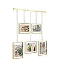 Umbra Exhibit photo display with five hanging frames (two 4x6 and three 5x7) suspended from a brushed metal ledge, on a white background.