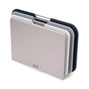 Compact set of three Joseph Joseph cutting boards with a space-saving design and metal handles.