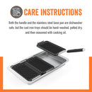 Grilling and serving set by Yukon Glory, featuring a large silver pan and three smaller black grill/sear trays with cooked food, plus a handle, all next to its product packaging.