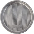 Nordic Ware 9-inch round aluminum cake pan with embossed grid texture, displayed on a white background.