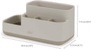 Joseph Joseph EasyStore bathroom caddy in ecru with divided compartments on a white background.