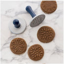 baked cookies, each with starry round designs, shown on a marble background.