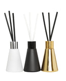 Set of three elegant fragrance diffusers in black, white, and gold bottles displayed side by side on a white background, ideal for home décor or gifting.