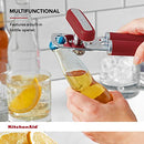 Red handled KitchenAid can opener with a silver cutting mechanism and bottle opener.