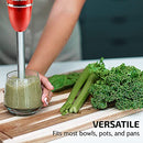 Red OVENTE immersion blender mixing a fresh smoothie in a clear glass container, surrounded by fruits and vegetables on a kitchen counter.