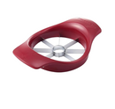 Red KitchenAid fruit slicer with stainless steel blades and ergonomic handles on a white background.