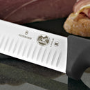 A detailed view of the Victorinox logo and Granton blade, highlighting the precision craftsmanship and stainless steel finish.