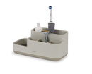 Joseph Joseph EasyStore bathroom caddy in ecru with divided compartments on a white background.