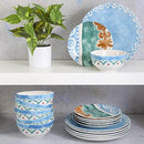 A complete 18-piece porcelain dinnerware set in an off-white color, accented with a warm saffron-toned pattern, from the Spice by Tia Mowry collection.