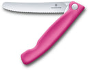 Victorinox foldable serrated knife with a pink handle and stainless steel blade, displayed on a white background.