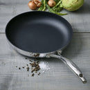 Close-up of ScanPan HaptIQ 11-inch skillet with pepper and vegetables on a wood counter