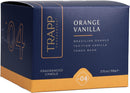 The Trapp No. 4 Orange Vanilla Small Poured Candle burning, creating a warm and inviting ambiance next to its stylish packaging.