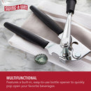 Swing-A-Way can opener on a kitchen towel, shown with integrated bottle opener and bottle cap