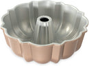 Nordic Ware toffee-colored classic Bundt pan with fluted edges and a center tube on a white background.