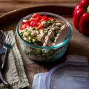 Packaged Snapware Total Solution glass food storage container, showing the brand, Pyrex compatibility, and key features like the USA origin and write & erase lid.