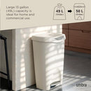 White trash can placed by counter with illustrated capacity info