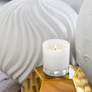 The Trapp No. 25 Lavender de Provence candle lit and displayed in a stylish setting with gold and white decor elements.