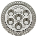 A 38 cm silver-colored plastic Passover Seder plate with intricate embossed detailing and six labeled sections for traditional Seder foods, featuring Hebrew and English inscriptions.