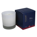 Trapp No. 24 Wild Currant 7 oz. Signature Candle in a frosted white glass container, placed next to its navy and red packaging.