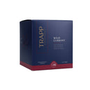 The Trapp No. 24 Wild Currant Signature Candle burning, creating a warm and inviting ambiance.