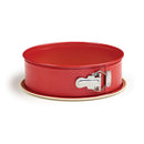 Side view of a 9-inch red springform pan with a metal latch and beige nonstick base.
