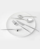 Five-piece set scattered across a white ceramic plate