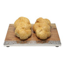 Challah board holding two braided loaves, featuring decorative silver metal cutout at the base and raised feet