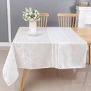 Silver diamond-patterned jacquard polyester tablecloth elegantly draped over a long dining table