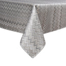 Elegant gray tablecloth with a chevron pattern, draping over the edge of a table, showcasing its textured fabric.