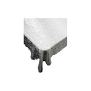 A cross-section of cured concrete showing a smooth, grey surface and a rough, darker edge, with small drips of wet concrete visible.