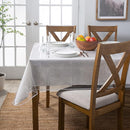 Clear vinyl protector covering a rectangular dining table, showcasing the tablecloth underneath.