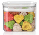 A 0.7qt Plastic Food Storage Container from Kettleandcords is filled with heart-shaped cookies adorned with colorful sprinkles, featuring hues of red, green, yellow, and white. The container includes a white lid, and the cookies are neatly stacked inside.
