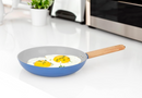 Stylish blue non-stick skillet with natural wood handle, perfect for everyday cooking.