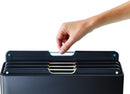 The image shows a Joseph Joseph Folio 4-Piece Cutting Board Set. It consists of a sleek, dark-colored (likely black or dark gray) storage case that holds four individual cutting boards. The tops of the cutting boards are visible, showing different colored tabs, which are typically used for hygienic separation of food types (e.g., raw meat, vegetables, cooked food, fish). The Joseph Joseph logo is visible on the lower front of the case.