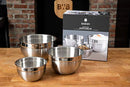 Three round, silver, shiny bowls of varying sizes, arranged from largest to smallest, showing a reflective surface.