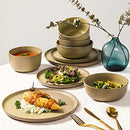 Cream-colored 16-piece stoneware dinnerware set with dinner plates, salad plates, soup bowls, and smaller bowls on a white background.