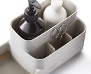 Joseph Joseph EasyStore bathroom caddy in ecru with divided compartments on a white background.
