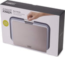 Compact set of three Joseph Joseph cutting boards with a space-saving design and metal handles.