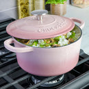 3-Quart Enameled Cast Iron Dutch Oven – Blush Pink with food on the stove