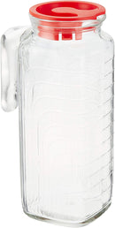 A clear glass pitcher with a vertical ribbed design, featuring a sturdy glass handle and a bright red plastic lid.