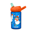 A blue CamelBak Eddy+ Kids water bottle with an orange lid and bite valve. The bottle features a winter scene with two cartoon snowmen wearing hats, scarves, and mittens, enjoying winter activities like skiing and catching snowflakes. White and blue snowflakes are scattered across the bottle. The CamelBak logo appears in orange on the lid and in white near the bottom of the bottle.