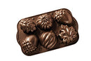 Nordic Ware bronze-finish cast aluminum autumn treats pan with seasonal mold shapes, shown on a white background.