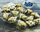 The scone pan filled with golden-baked mini scones cooling on a kitchen counter.