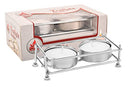 A set of white tealight candles in a Kettleandcords Nickel Plated Tealight Holder is displayed in front of its packaging, which has a clear window revealing 36 tealights inside.